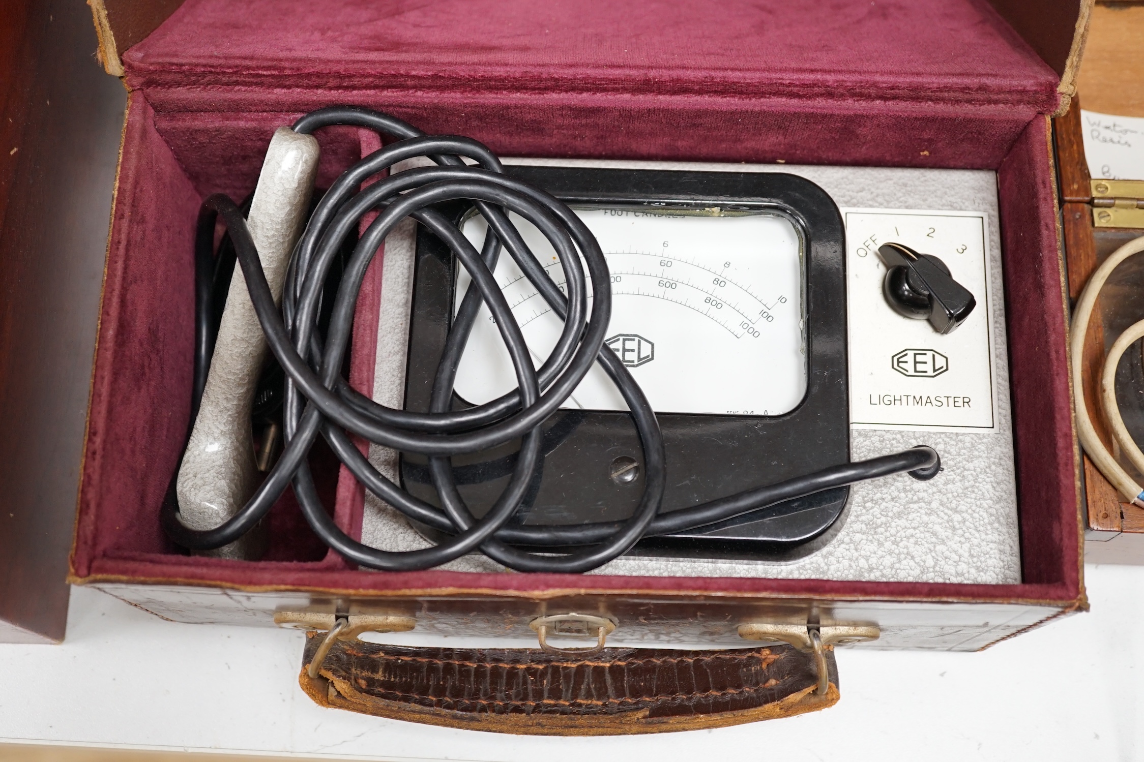 A writing slope, humidor and contents including a silver mounted cigar case, an Evans Electroselenium Ltd. light meter and a Weston Voltmeter. Condition - fair.